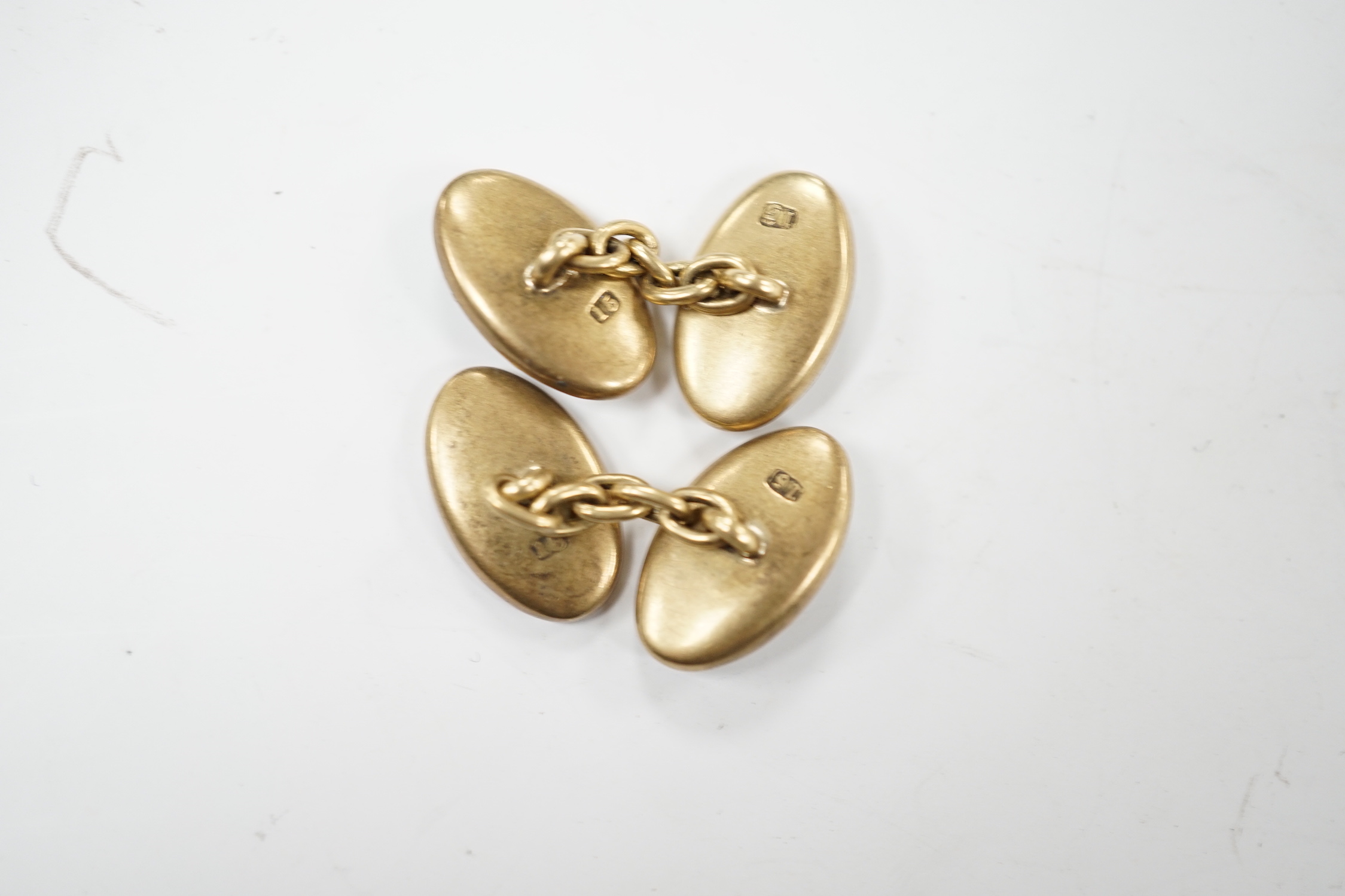 A pair of Edwardian 15ct, mother of pearl and seed pearl set oval cufflinks, 17mm, gross weight 7.3 grams.